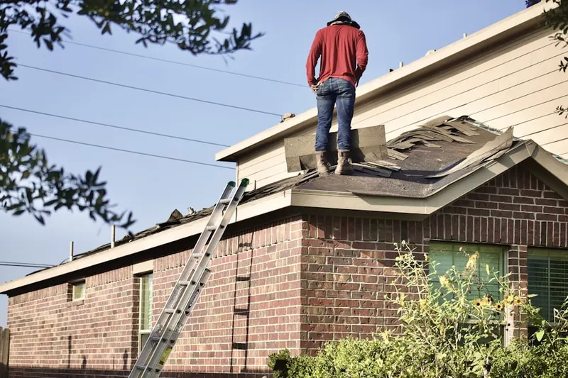 Professional roofer working on a residential roof in Concord